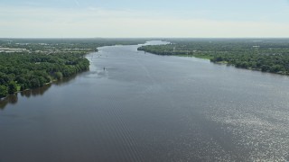 AX82_040 - 4.8K aerial stock footage of Delaware River bordered by trees in Bensalem, Pennsylvania