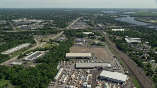 AX82_050 - 4.8K aerial stock footage flying over warehouse buildings to approach Interstate 276 in Bristol, Pennsylvania