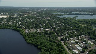 AX82_056 - 4.8K aerial stock footage flying over a mobile home park near a lake in Morrisville, Pennsylvania