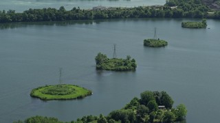 AX82_057 - 4.8K stock footage aerial video of power lines across Van Sciver Lake, Morrisville, Pennsylvania