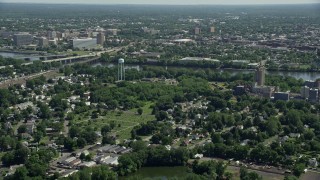 AX82_058E - 4.8K stock footage aerial video flying over homes and cemetery in Morrisville, Pennsylvania, approach Trenton, New Jersey across the Delaware River