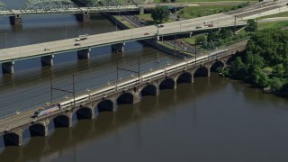 AX82_060 - 4.8K aerial stock footage of a commuter train crossing the Morrisville-Trenton Railroad Bridge in Trenton, New Jersey