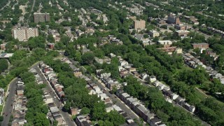 AX82_074 - 4.8K aerial stock footage flying by and tilting to row houses and trees, Trenton, New Jersey