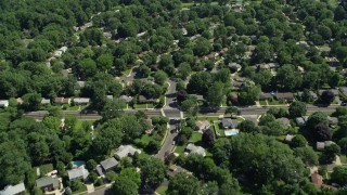 AX82_080 - 4.8K aerial stock footage flying over suburban neighborhoods among trees, Lawrenceville, New Jersey