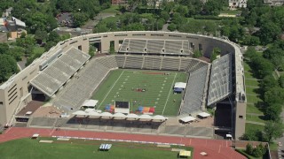 AX82_102 - 4.8K aerial stock footage of football practice at Princeton University Stadium, New Jersey