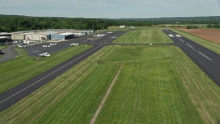 AX82_108 - 4.8K aerial stock footage of a small plane taxiing at Princeton Airport, New Jersey
