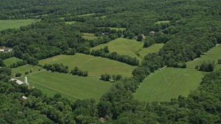 AX83_006 - 4.8K aerial stock footage of upscale homes by farm fields, Belle Mead, New Jersey