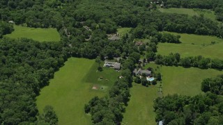 AX83_007 - 4.8K aerial stock footage of upscale homes and green fields in Belle Mead, New Jersey