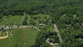 AX83_012 - 4.8K aerial stock footage of a baseball field and a country home in Princeton, New Jersey