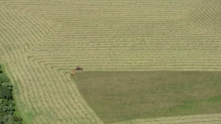 AX83_038 - 4.8K aerial stock footage of a tractor harvesting crops in Princeton, New Jersey