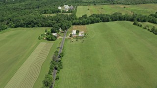 AX83_039 - 4.8K aerial stock footage flying over fields and barns beside Canal Road in Franklin Park, New Jersey
