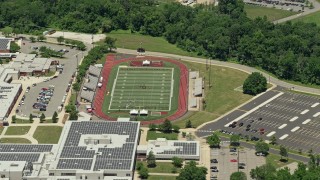 AX83_051 - 4.8K aerial stock footage of a high school football field in Piscataway Township, New Jersey