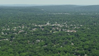 AX83_061 - 4.8K aerial stock footage of a church steeple rising above buildings in small town of Westfield, New Jersey