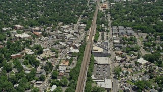 AX83_065E - 4.8K aerial stock footage of shops and homes around railroad tracks in Cranford, New Jersey