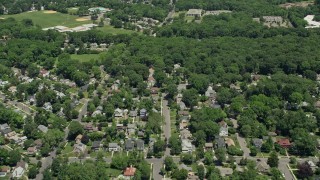 AX83_067E - 4.8K aerial stock footage flying over suburban homes to approach office building in Cranford, New Jersey