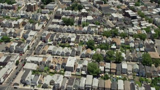 AX83_097 - 4.8K aerial stock footage tilting from urban Newark homes to reveal and approach Manhattan skyline in the background, New Jersey & New York