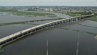 AX83_101E - 4.8K aerial stock footage of New Jersey Turnpike bridge over the Hackensack River in Kearny, New Jersey