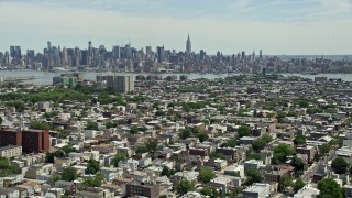 AX83_106E - 4.8K stock footage aerial video of Midtown Manhattan skyline seen from Jersey City urban neighborhoods, New Jersey & New York