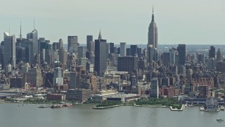 AX83_109 - 4.8K aerial stock footage of Midtown Manhattan skyline and Hudson Yards seen from Hudson River, New York City