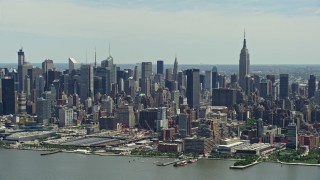 AX83_110 - 4.8K aerial stock footage of West Side Yard, Hudson Yards, and Midtown Manhattan skyscrapers seen from Hudson River, New York City