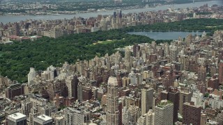 AX83_132 - 4.8K stock footage aerial video flying over Upper East Side apartment buildings to approach Central Park, New York City