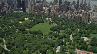 AX83_134 - 4.8K stock footage aerial video of Sheep Meadow in Central Park with trees, New York City