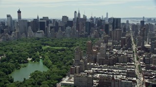 AX83_137 - 4.8K stock footage aerial video of Midtown Manhattan skyscrapers and Central Park, New York City