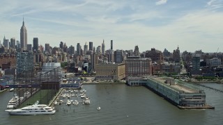 AX83_154 - 4.8K aerial stock footage panning across piers and riverfront apartment buildings, Chelsea and Greenwich Village, New York City