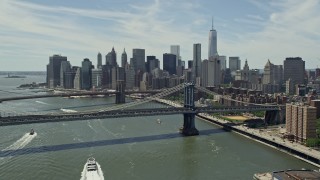 AX83_183E - 4.8K aerial stock footage fly over Manhattan Bridge to approach Brooklyn Bridge and the Lower Manhattan skyline, New York City