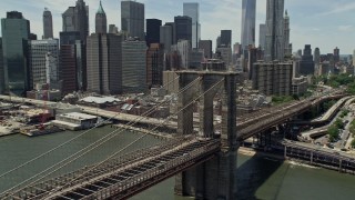 AX83_188 - 4.8K aerial stock footage of Brooklyn Bridge near the Lower Manhattan skyline, New York City