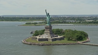 AX83_193 - 4.8K aerial stock footage flying by Statue of Liberty with tourists in New York Harbor, New York City