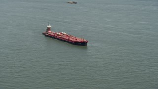 AX83_203 - 4.8K aerial stock footage of an oil tanker sailing New York Harbor, New York