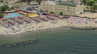 AX83_211 - 4.8K aerial stock footage of beach goers on Coney Island Beach, Brooklyn, New York City
