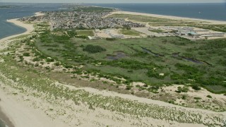 AX83_223 - 4.8K stock footage aerial video flying over the Breezy Point Surf Club, Queens, New York