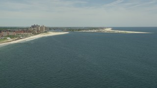 AX83_232 - 4.8K aerial stock footage approaching beach, apartment complexes, and East Rockaway Inlet in Atlantic Beach, Long Island, New York