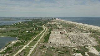 AX83_249E - 4.8K aerial stock footage flying over beach and coastal roads in Jones Beach State Park, Wantagh, New York