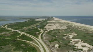 AX83_251 - 4.8K aerial stock footage flying between coastal road and beach at Jones Beach State Park, Wantagh, New York
