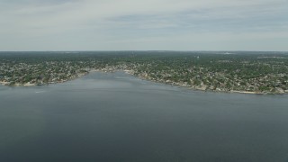 AX83_257E - 4.8K aerial stock footage approaching Massapequa from small marshy islands in South Oyster Bay in New York
