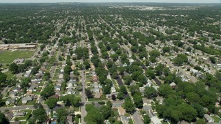 AX83_262E - 4.8K aerial stock footage flying over State Route 27 and suburban neighborhoods in Massapequa Park, New York