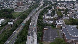 AX84_001 - 4K aerial stock footage Flying over Jersey Turnpike, tilt up, Jersey City, New Jersey