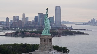 AX84_013E - 4K aerial stock footage orbiting from the side to the front of the Statue of Liberty, New York, New York