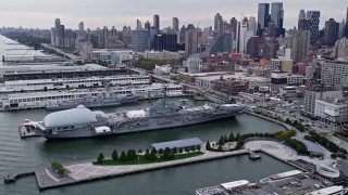 AX84_023E - 4K aerial stock footage approach and flyby USS Intrepid, Midtown Manhattan, New York City