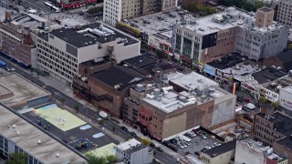 AX84_038 - 4K aerial stock footage Flying over shops in Harlem, New York, New York