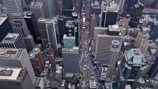 AX84_050E - 4K aerial stock footage fly over Times Square and tilt to a bird's eye view, Midtown Manhattan, New York City