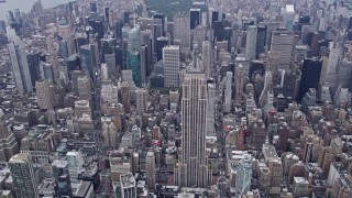 AX84_059E - 4K aerial stock footage of approaching the iconic Empire State Building, Midtown Manhattan, New York City