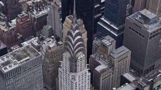 AX84_072E - 4K aerial stock footage approach and tilt to bird's eye view of top of Chrysler Building, Midtown Manhattan, New York City