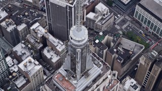 AX84_074E - 4K aerial stock footage approach top of Empire State Building, tilt to bird's eye view, Midtown Manhattan, New York City