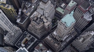 AX84_086E - 4K aerial stock footage of approaching 40 Wall Street, tilt to bird's eye view in Lower Manhattan, New York City