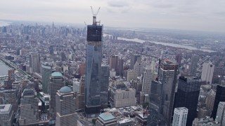 AX84_089E - 4K aerial stock footage tilt from Lower Manhattan, reveal One World Trade Center, New York, New York