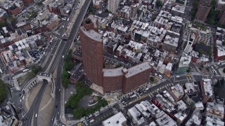 AX84_095 - 4K aerial stock footage of Confucius Plaza, Manhattan Bridge, Brooklyn Bridge, East River, New York, New York